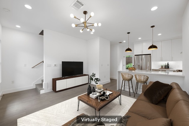 1204 W 51st St Unit 2, Austin, TX 78756 - living room with light wood-style flooring, baseboards, recessed lighting, stairway, and a chandelier