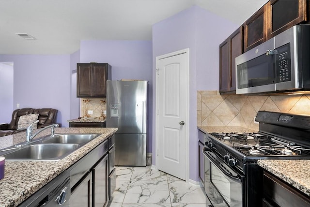 kitchen featuring black appliances, a sink, light marble finish flooring, dark brown cabinets, and decorative backsplash