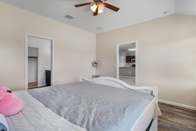 bedroom featuring wood finished floors, baseboards, ceiling fan, and lofted ceiling