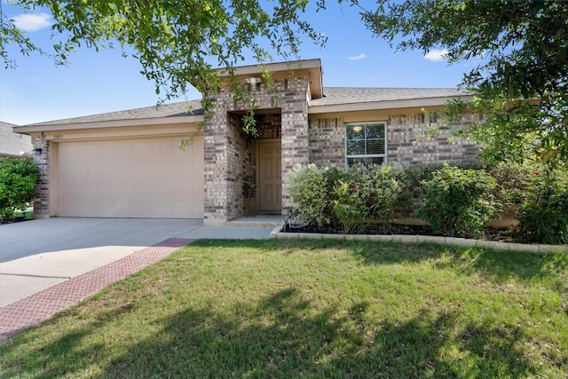 view of front of house featuring an attached garage, driveway, a front lawn, and brick siding