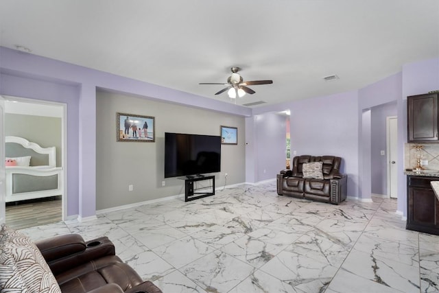 living room featuring ceiling fan, baseboards, and light marble finish floors