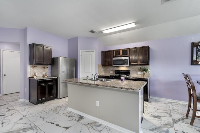 kitchen featuring stainless steel appliances, light marble finish floors, a sink, dark brown cabinets, and lofted ceiling