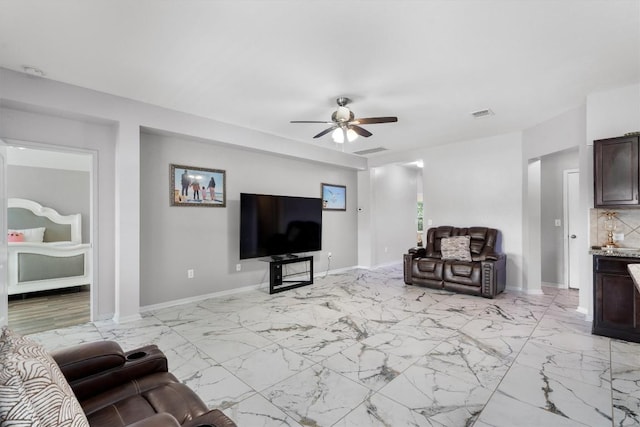 15013 Roody Ln, Austin, TX 78725 - living area featuring a ceiling fan, baseboards, and light marble finish floors