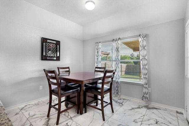 15013 Roody Ln, Austin, TX 78725 - dining space with light marble finish flooring, baseboards, and lofted ceiling