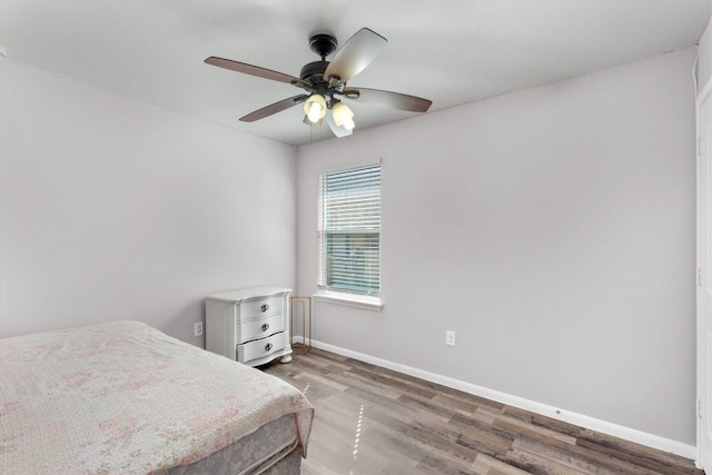 15013 Roody Ln, Austin, TX 78725 - bedroom featuring wood finished floors, baseboards, and ceiling fan