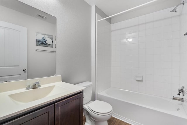 15013 Roody Ln, Austin, TX 78725 - full bath featuring toilet, vanity, shower / washtub combination, and wood finished floors