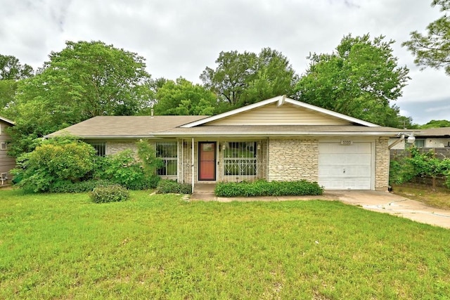 ranch-style house featuring an attached garage, a front lawn, and driveway