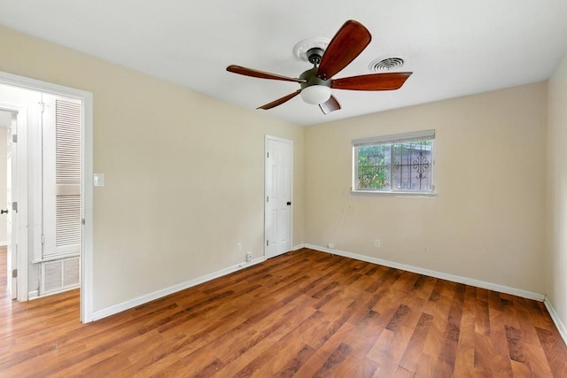 unfurnished room featuring baseboards, a ceiling fan, and wood finished floors