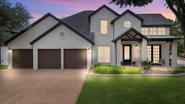 12013 Tarraza Ct, Austin, TX 78732 - view of front facade featuring brick siding, driveway, a yard, and an attached garage