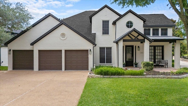 12013 Tarraza Ct, Austin, TX 78732 - view of front of house featuring brick siding, concrete driveway, a front lawn, and covered porch