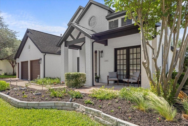 12013 Tarraza Ct, Austin, TX 78732 - view of front of house featuring brick siding, a porch, an attached garage, and roof with shingles