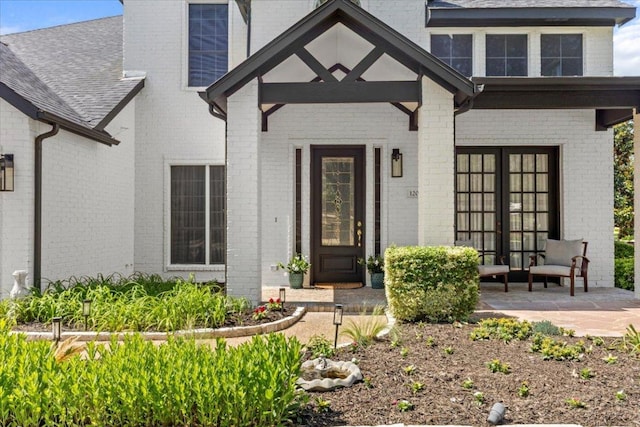 12013 Tarraza Ct, Austin, TX 78732 - entrance to property with brick siding, french doors, and roof with shingles