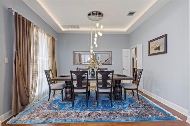 12013 Tarraza Ct, Austin, TX 78732 - dining space featuring a raised ceiling, baseboards, and wood finished floors