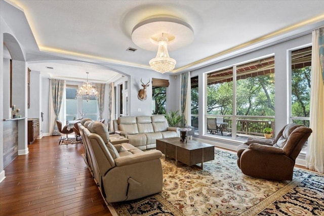 12013 Tarraza Ct, Austin, TX 78732 - living room featuring a chandelier, hardwood / wood-style floors, baseboards, and arched walkways