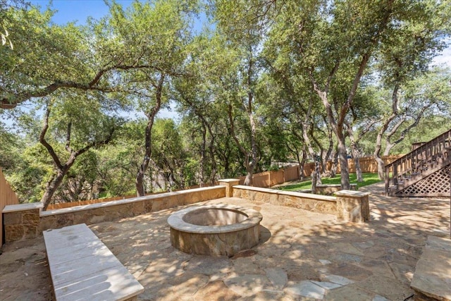 12013 Tarraza Ct, Austin, TX 78732 - view of patio / terrace with a fire pit, a fenced backyard, and stairs