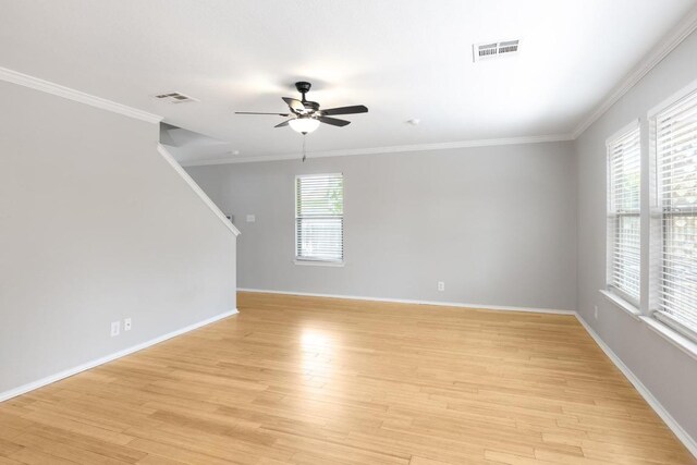 601 Abundance Ln, Kyle, TX 78640 - empty room with a ceiling fan, light wood-style flooring, baseboards, crown molding, and stairs