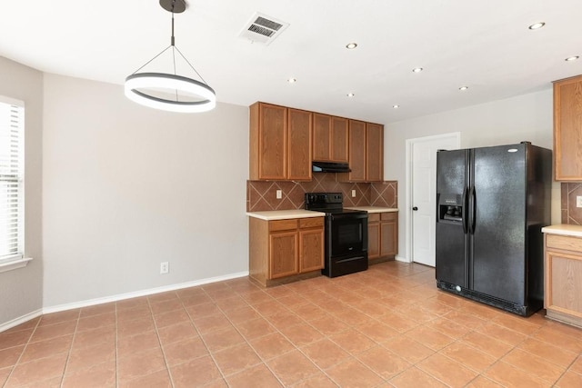 601 Abundance Ln, Kyle, TX 78640 - kitchen with black appliances, under cabinet range hood, backsplash, light countertops, and recessed lighting
