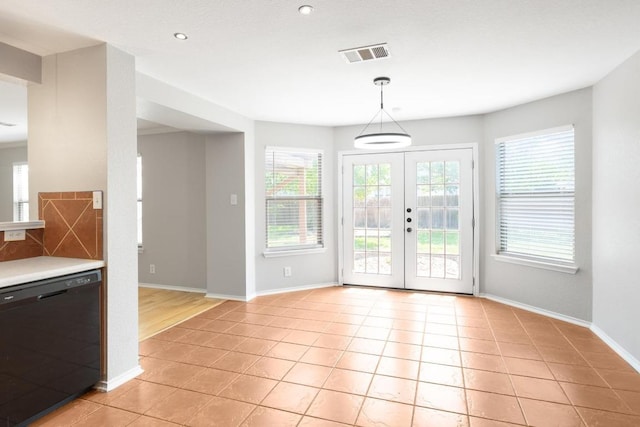 601 Abundance Ln, Kyle, TX 78640 - unfurnished dining area featuring light tile patterned floors, baseboards, recessed lighting, and french doors