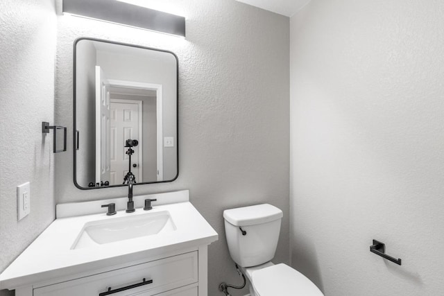 601 Abundance Ln, Kyle, TX 78640 - half bath with toilet, vanity, and a textured wall
