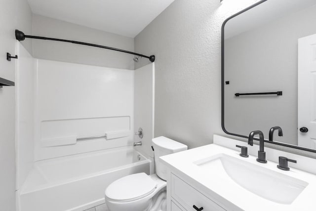 601 Abundance Ln, Kyle, TX 78640 - full bathroom with toilet, vanity,  shower combination, and a textured wall