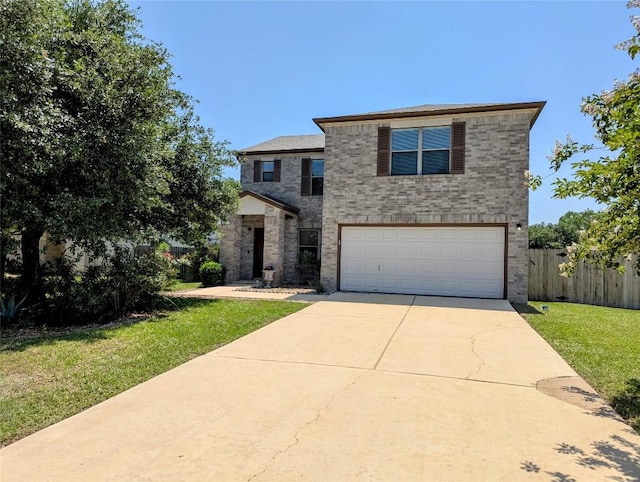 601 Abundance Ln, Kyle, TX 78640 - traditional-style home featuring a garage, brick siding, and driveway