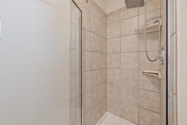 full bath featuring a shower stall