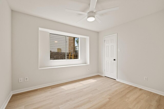 unfurnished room with light wood-style floors, a ceiling fan, and baseboards