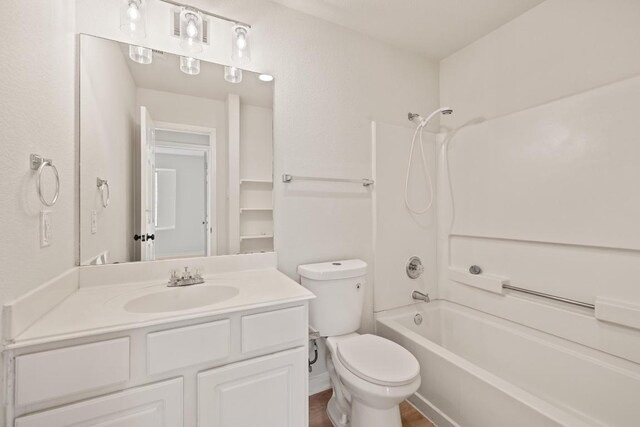 bathroom with toilet, shower / bathtub combination, and vanity