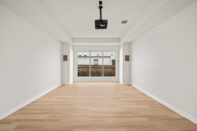 spare room featuring light wood-style flooring and baseboards