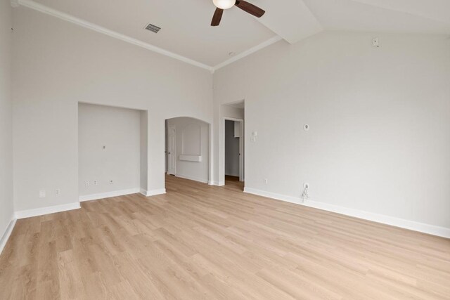 empty room with ceiling fan, light wood finished floors, baseboards, high vaulted ceiling, and arched walkways