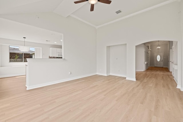 unfurnished living room with a ceiling fan, light wood-style floors, arched walkways, baseboards, and lofted ceiling
