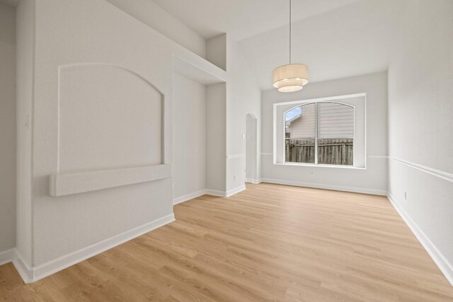 spare room with light wood-type flooring and baseboards