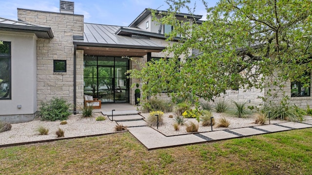 13213 Meridian Park Blvd, Austin, TX 78739 - property entrance featuring a standing seam roof, metal roof, stone siding, and a chimney