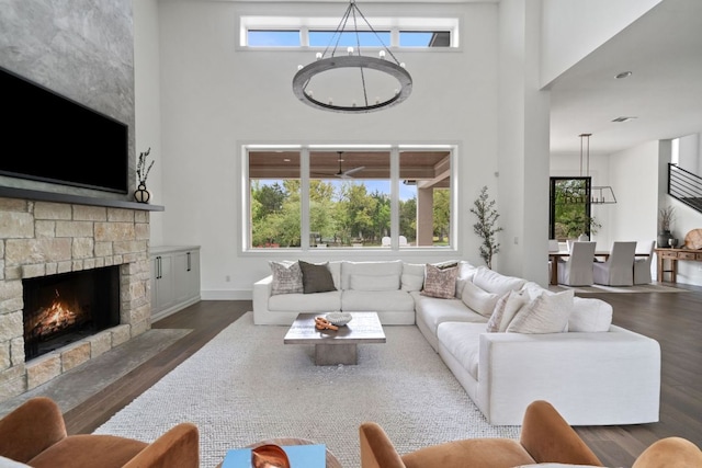 13213 Meridian Park Blvd, Austin, TX 78739 - living area with a high ceiling, wood finished floors, a stone fireplace, and baseboards