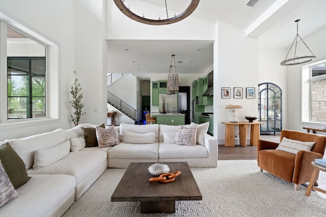 13213 Meridian Park Blvd, Austin, TX 78739 - living room featuring a high ceiling, stairway, a chandelier, and light carpet