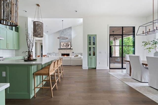 13213 Meridian Park Blvd, Austin, TX 78739 - kitchen with green cabinets, dark wood finished floors, decorative backsplash, and recessed lighting
