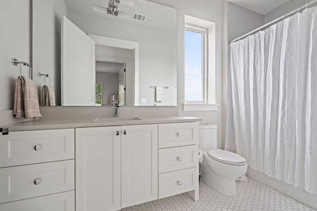 13213 Meridian Park Blvd, Austin, TX 78739 - bathroom with plenty of natural light, toilet, vanity, and tile patterned floors