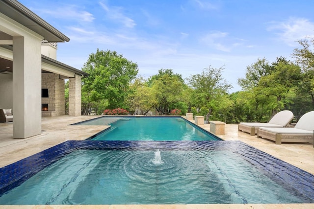 13213 Meridian Park Blvd, Austin, TX 78739 - view of swimming pool with an outdoor stone fireplace, a patio, and a pool with connected hot tub