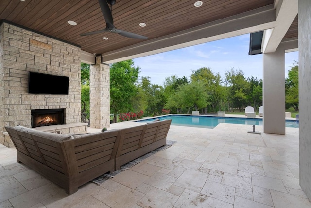 13213 Meridian Park Blvd, Austin, TX 78739 - view of patio with an outdoor living space with a fireplace, an outdoor pool, a ceiling fan, and view of wooded area