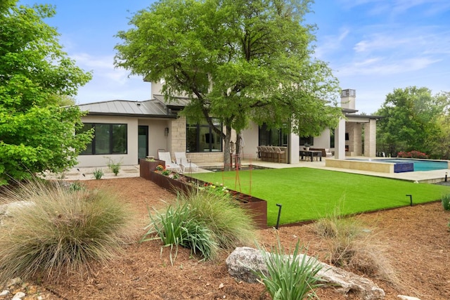 13213 Meridian Park Blvd, Austin, TX 78739 - rear view of house featuring a standing seam roof, an outdoor pool, stone siding, a patio, and a yard