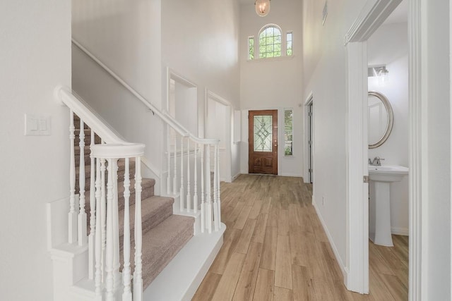 12207 Carlsbad Dr, Austin, TX 78738 - entrance foyer with a towering ceiling, light wood finished floors, and stairway