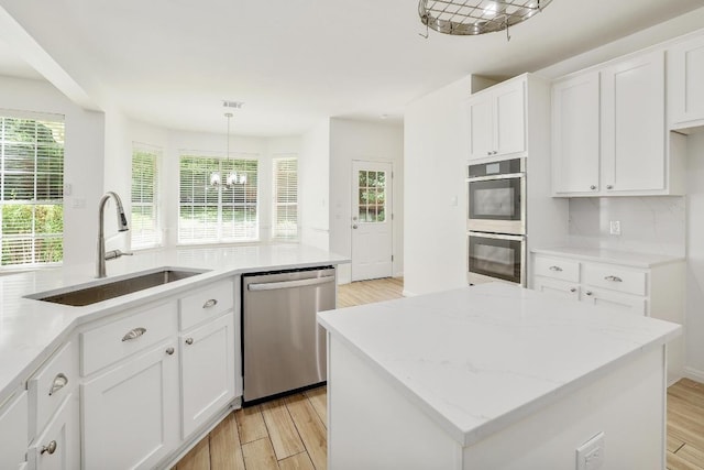 12207 Carlsbad Dr, Austin, TX 78738 - kitchen featuring stainless steel appliances, light wood finished floors, healthy amount of natural light, and white cabinets