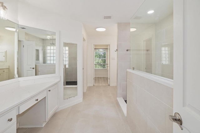 12207 Carlsbad Dr, Austin, TX 78738 - full bathroom with vanity, tile patterned floors, and a walk in shower