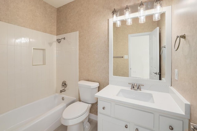 bathroom featuring toilet, vanity, and shower / bathtub combination