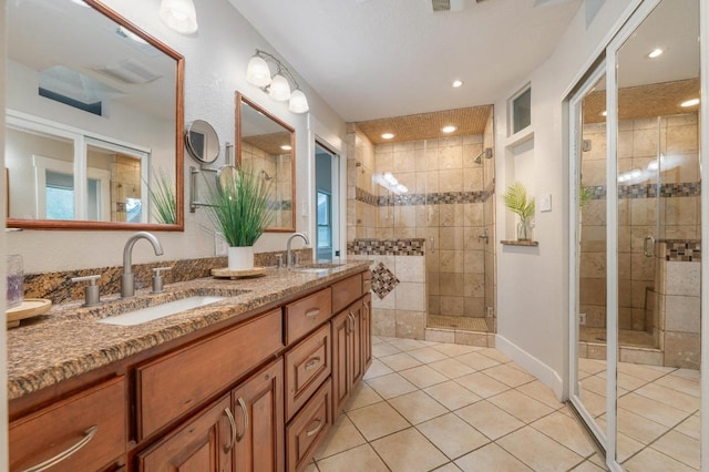 10305 Pickfair Dr, Austin, TX 78750 - full bath featuring tile patterned floors, a stall shower, double vanity, and recessed lighting