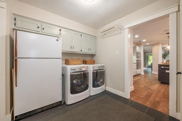 10305 Pickfair Dr, Austin, TX 78750 - laundry room featuring independent washer and dryer, dark tile patterned floors, cabinet space, recessed lighting, and a textured ceiling