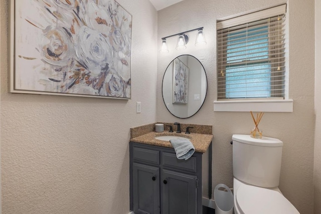 10305 Pickfair Dr, Austin, TX 78750 - bathroom featuring toilet, vanity, and a textured wall