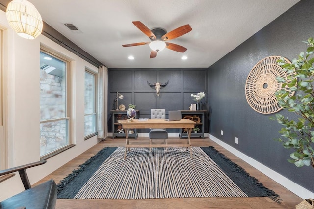 10305 Pickfair Dr, Austin, TX 78750 - office area with ceiling fan, a textured wall, wood finished floors, a decorative wall, and baseboards