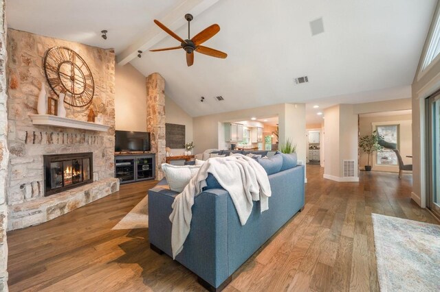 10305 Pickfair Dr, Austin, TX 78750 - living room with high vaulted ceiling, beam ceiling, a ceiling fan, wood finished floors, and a fireplace