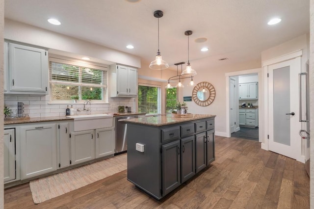 10305 Pickfair Dr, Austin, TX 78750 - kitchen with dishwasher, a sink, dark wood-style flooring, tasteful backsplash, and recessed lighting